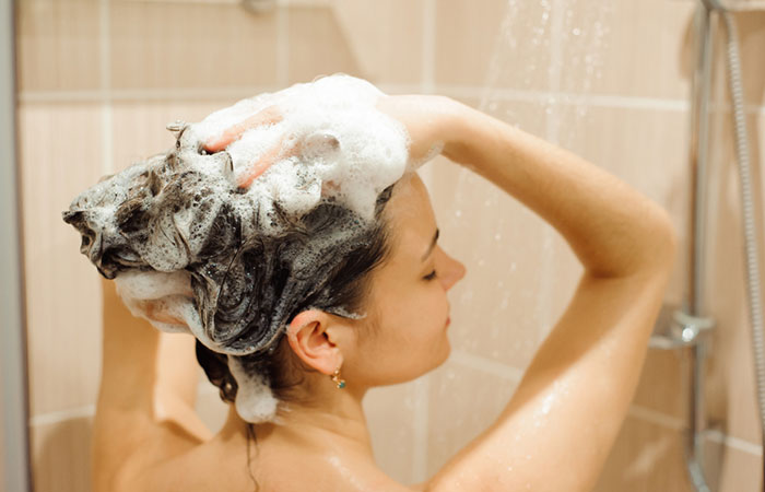 Woman using shampoo for healthy hair