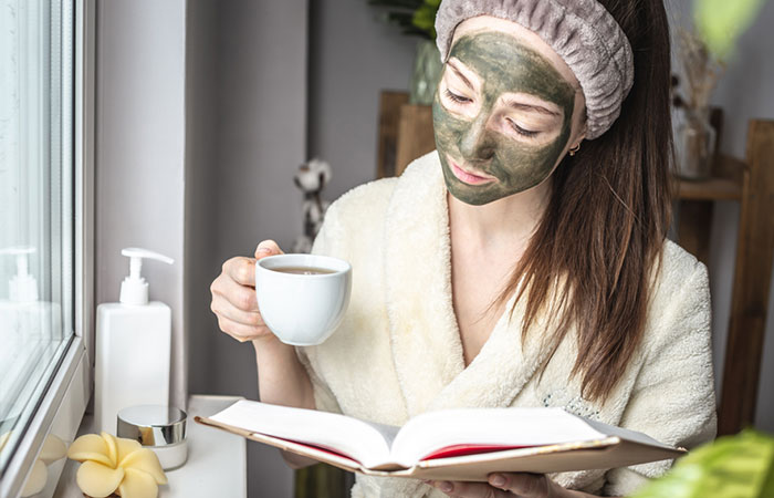 Woman with green tea face pack