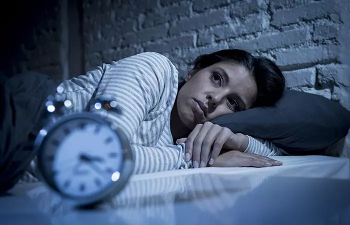 Woman with insomnia lying awake in bed