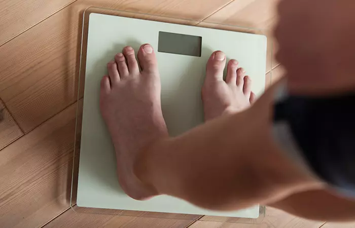 Woman experiencing weight gain due to excess consumption of almonds