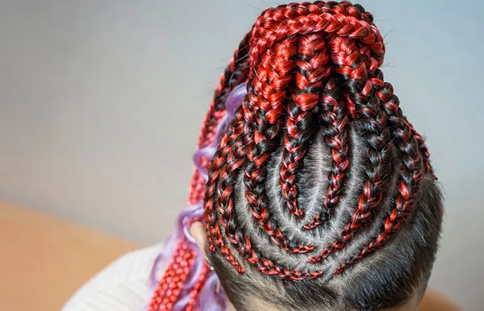 A woman in a beautifully colored crochet braid