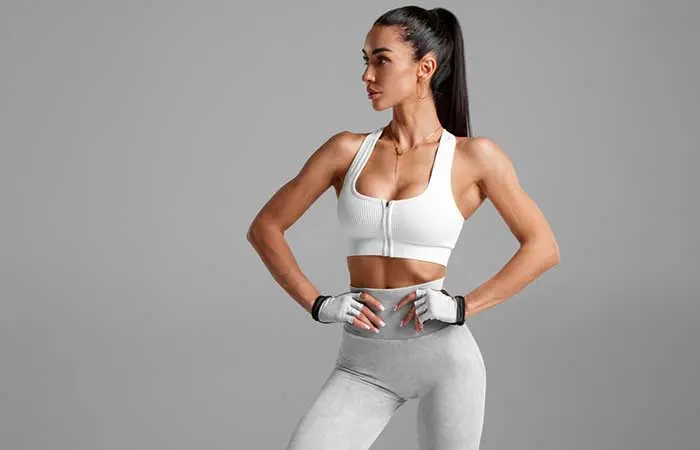 A woman in gym outfit sporting a sleek high ponytail hairstyle