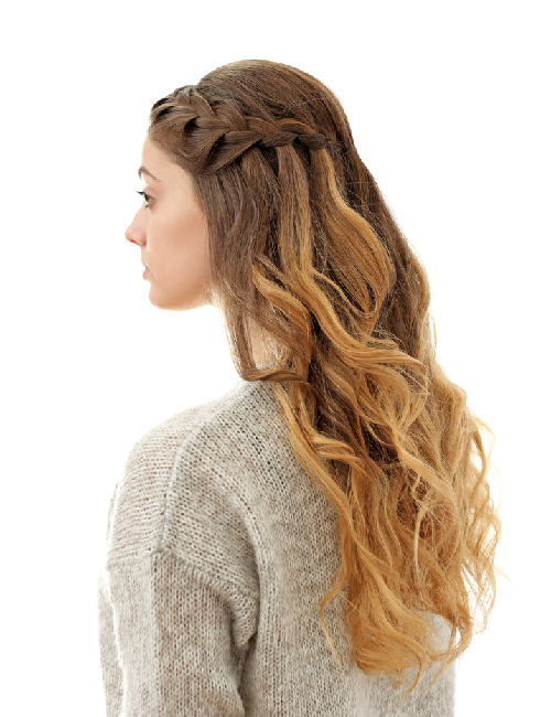 A woman with a waterfall braid with loose curls