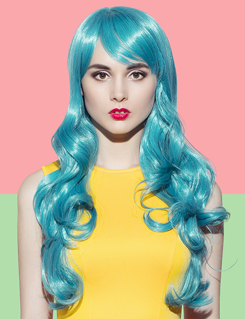 Electric blue curls and side swept fringe layered hairstyle