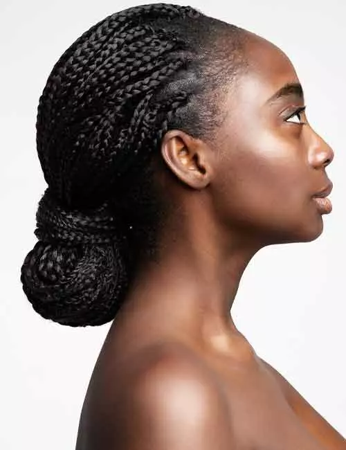 A sophisticated Ghana braids low bun hairstyle