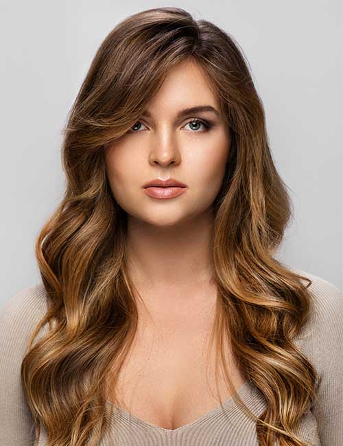 Long sweeping balayage hairstyle with side-swept bangs