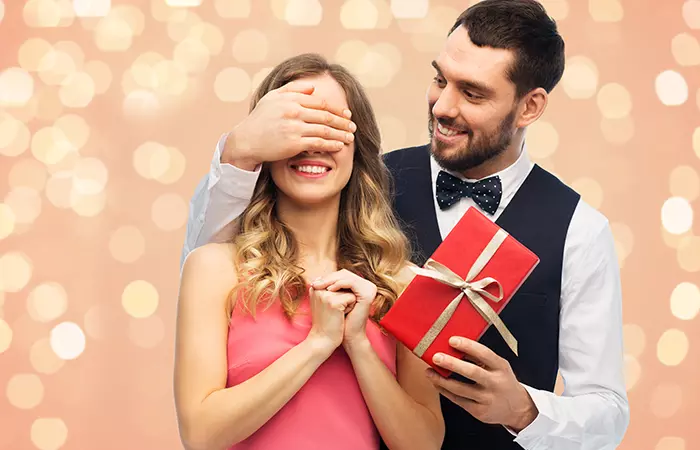 A happy man giving her special woman a surprise present