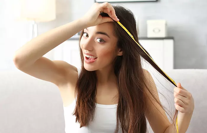 A woman experiencing hair growth as a benefit of beeswax for hair