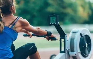 Woman using the rowing machine for Cardio EMOM Workouts