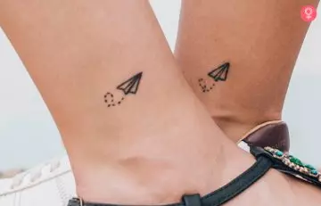 Close up of ankles with paper plane minimalist tattoo for mother and son