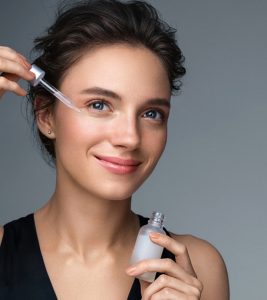 Women applying copper peptides serum to get beautiful and healthy skin