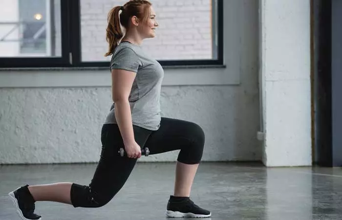 Woman performing lunges for full body EMOM Workouts