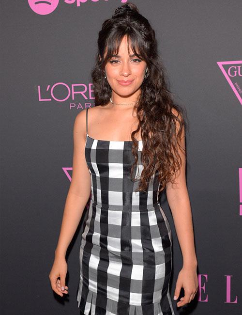 Long hair in a half knot with piece-y tousled curtain bangs