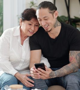 Mother and son checking out tattoo designs on a smartphone