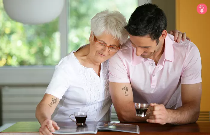 Mother and son drinking coffee showing their  butterfly and face line art minimalist tattoos