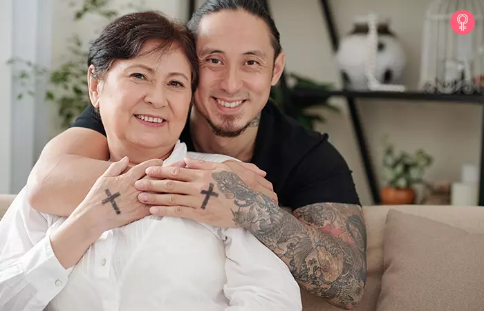 Mother and son duo showing off their matching cross mother son tattoo