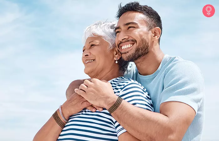 Mother and son embracing at the beach with tribal band arm mother son tattoos