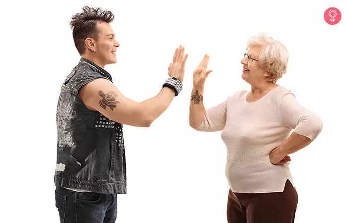 Mother and son with matching polynesian turtle mother son tattoo giving each other a hi five