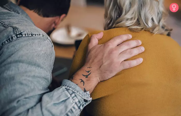 Mother son tattoo of a flock of birds on the back of the hand