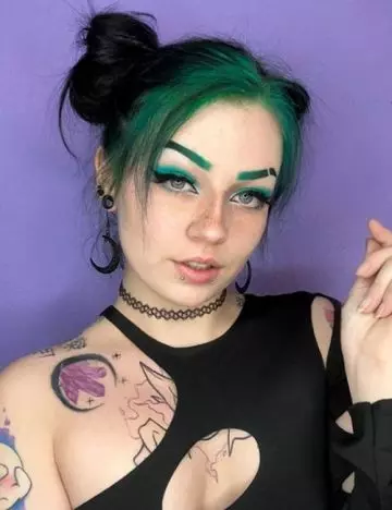 Space buns with dramatic green streaks