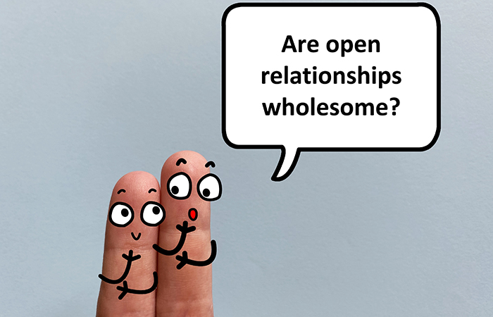Two fingers and a speech bubble wondering if open relationships are wholesome