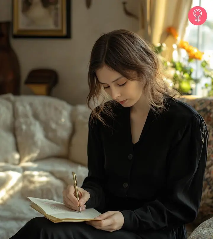 A woman writing thank you notes for the funeral to express her gratitude towards her loved ones