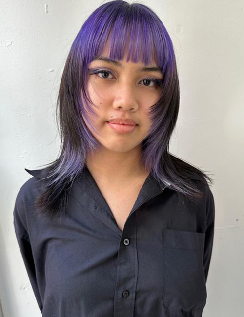 Wolf cut hairstyle with purple highlights