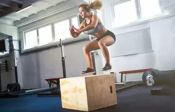 Woman doing box jumps to strengthen her quads