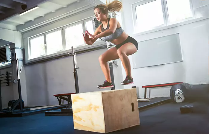 Woman doing box jumps to strengthen her quads