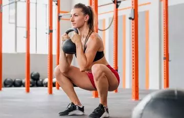 Woman doing goblet squats to strengthen her quads
