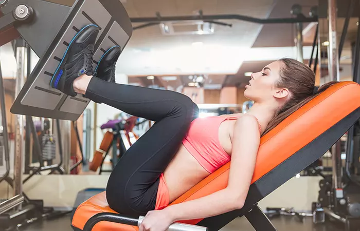 Woman doing leg press exercise to strengthen her quads