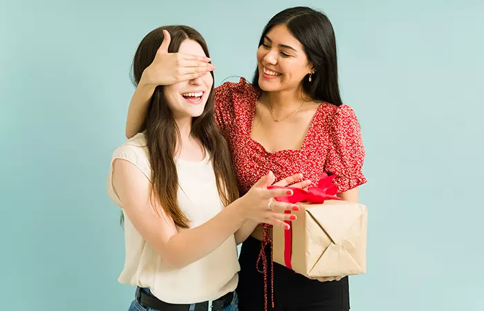 Woman giving birthday present to her sister-in-law