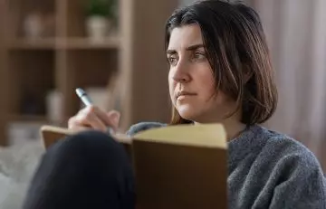 Woman thinking how to write thank you messages for support during bereavement