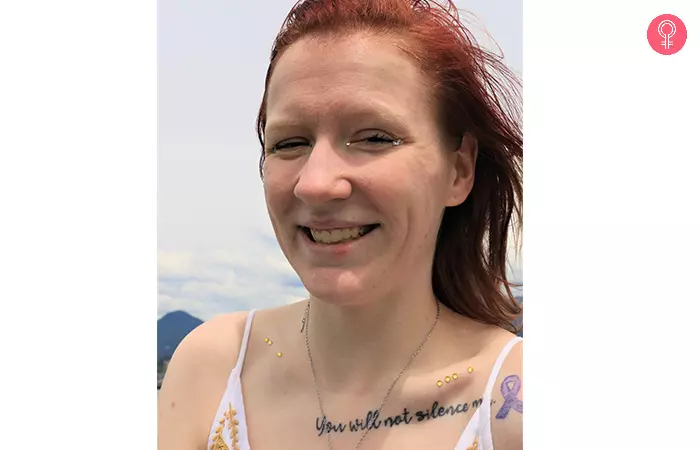 Woman with motivational quote tattoo on her collarbone as a mother son tattoo idea