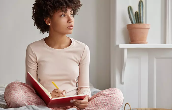 Women writing thank you message after funeral