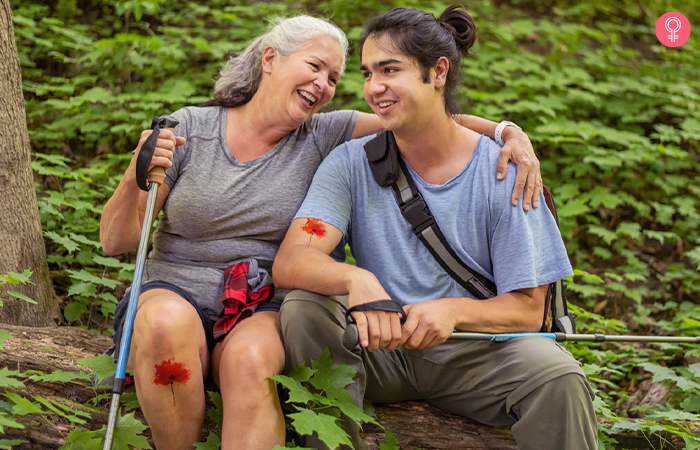 mother and son on a hike posing with their watercolor flower mother son tattoos