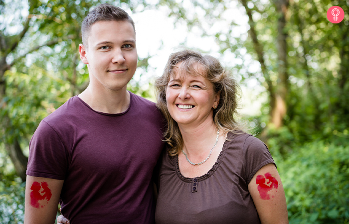 mother and son pose in the forest with their watercolor mother son tattoo