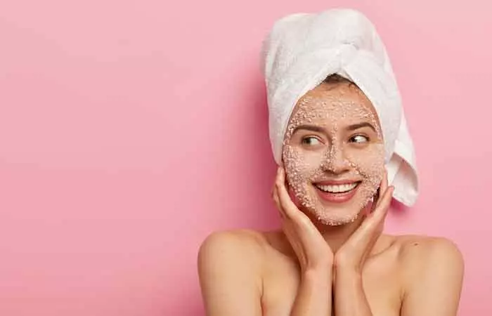 Woman with coffee scrub on her face to exfoliate blackheads