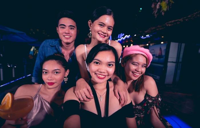 A happy woman clicking a selfie with her friends