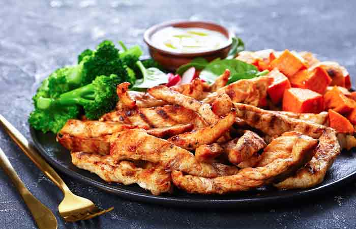 A plate of grilled chicken with steamed vegetables