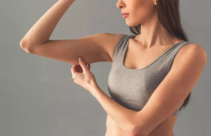 Woman checking her muscle while following a high-protein low-carb diet