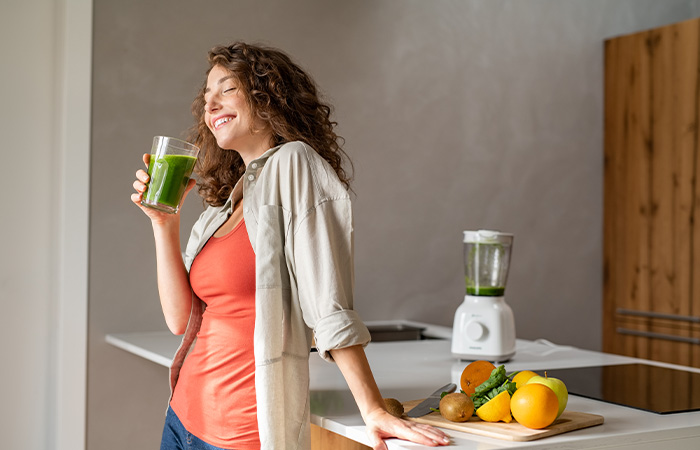 Woman drinking green smoothie for gastroparesis