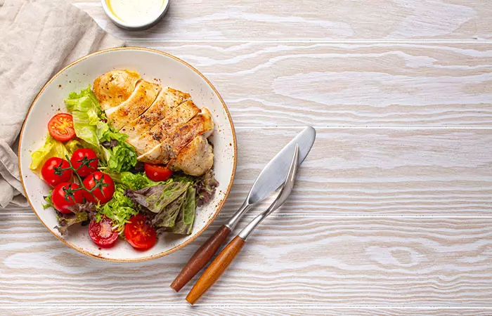 Optavia diet meal comprising a healthy green vegetable salad with grilled chicken breast.