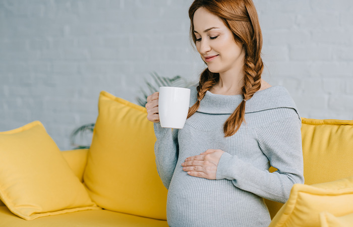 Pregnant woman drinking coffee