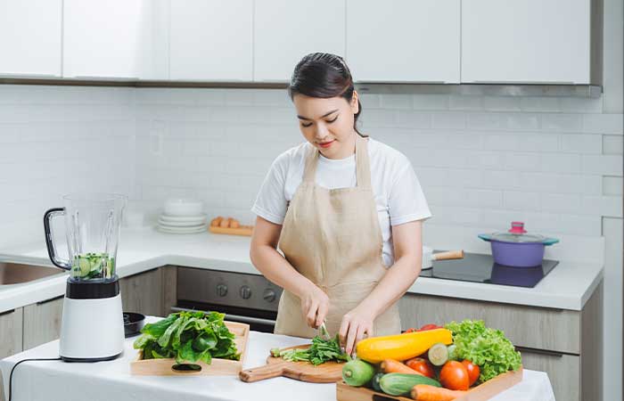 Woman chopping food to prepare purée