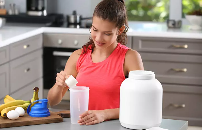 Woman making a high-protein shake with protein powder