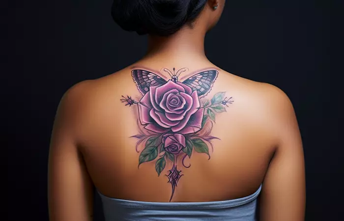 A butterfly and purple rose tattoo on the back