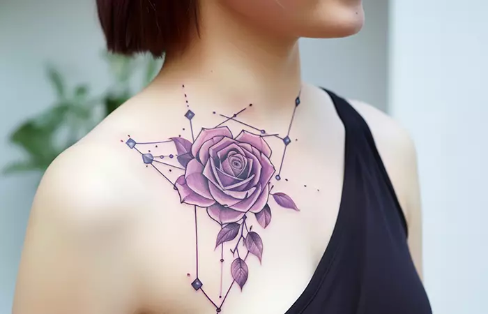 A celestial-themed purple rose tattoo near the collarbone