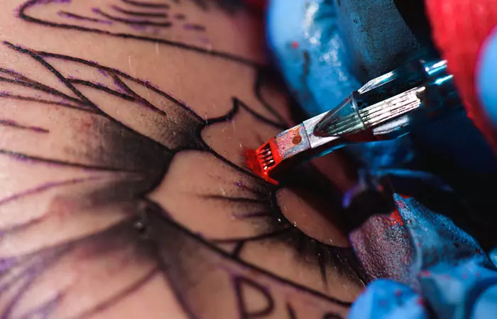 A close-up of tattoo ink being used on a person