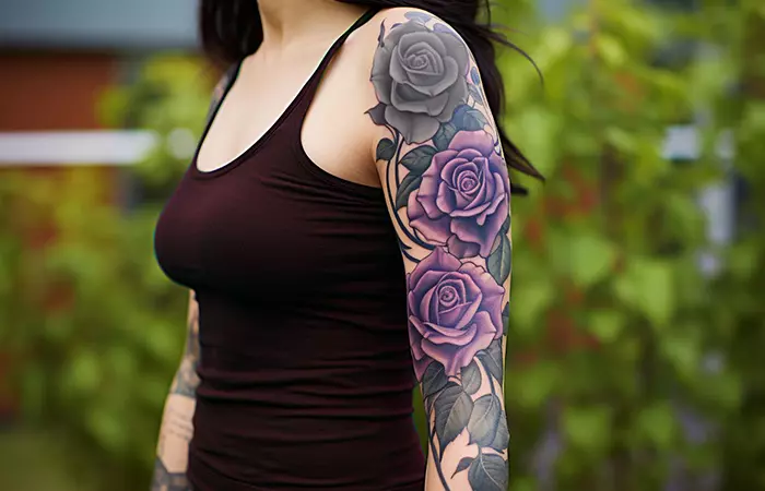 A graffiti-style black and purple rose tattoo